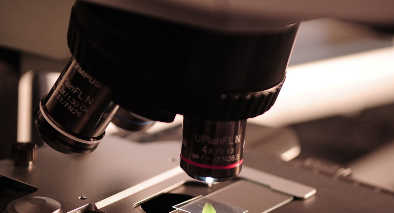 Close-up of a microscope looking at a sample on a glass slide