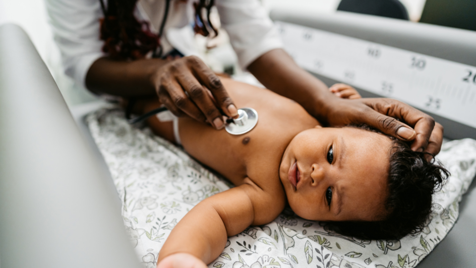 Baby is being checked over by a heath professional.