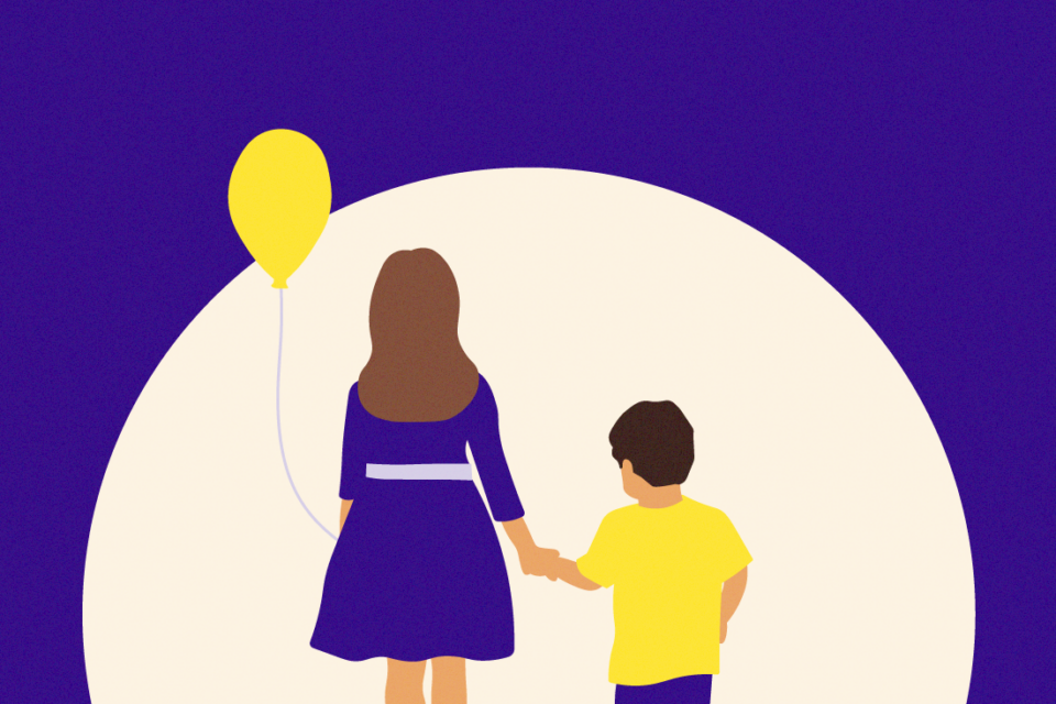 Two children standing side by side with their back to us. They are holding hands and the older child on the left is holding a yellow balloon.
