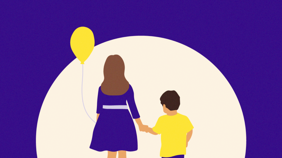 Two children standing side by side with their back to us. They are holding hands and the older child on the left is holding a yellow balloon.