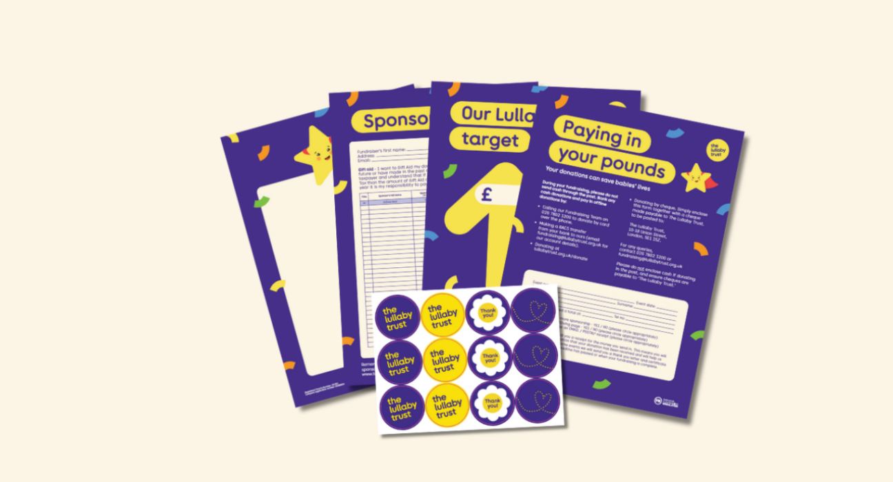 A selection of The Lullaby Trust's fundraising posters, stickers and other paper resources on a cream background