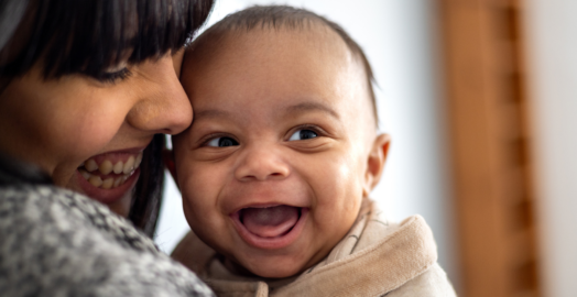 Baby smiling with mum