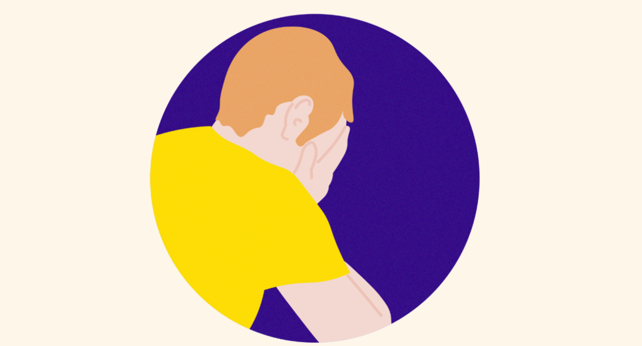 Man in a yellow t-shirt with his head in his hands, on a purple background.