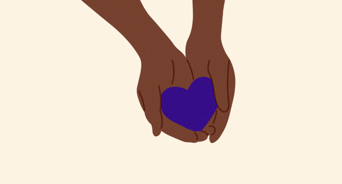 Hands holding a purple heart.
