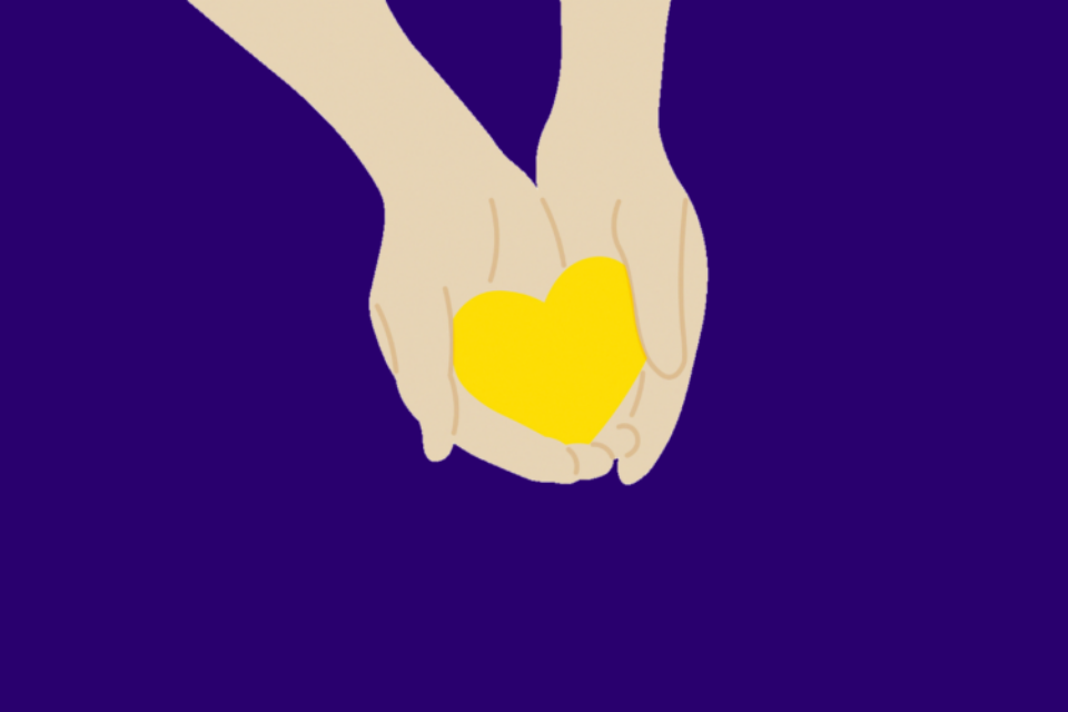Hands holding yellow heart on purple background.