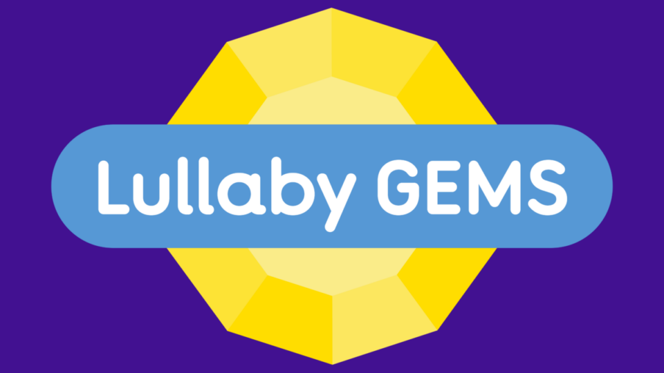 A yellow gemstone on a purple background. Through the middle of the gem is a blue banner with text that says 'Lullaby Gems'