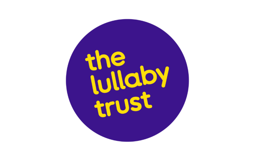 The Lullaby Trust's logo. It is a purple circle with curling text all in lowercase 'the lullaby trust'.