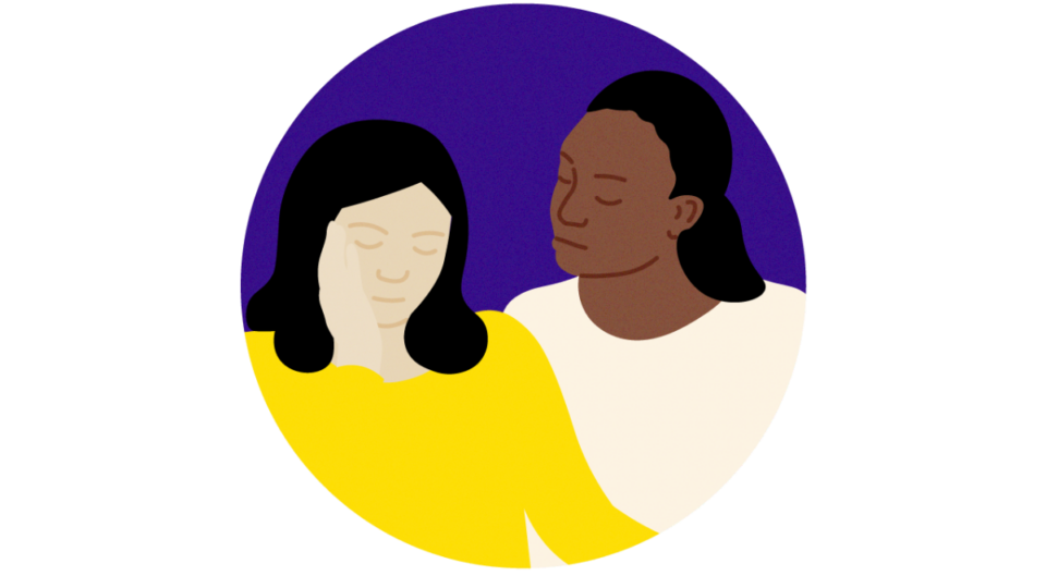 Lady sitting beside another person in support.