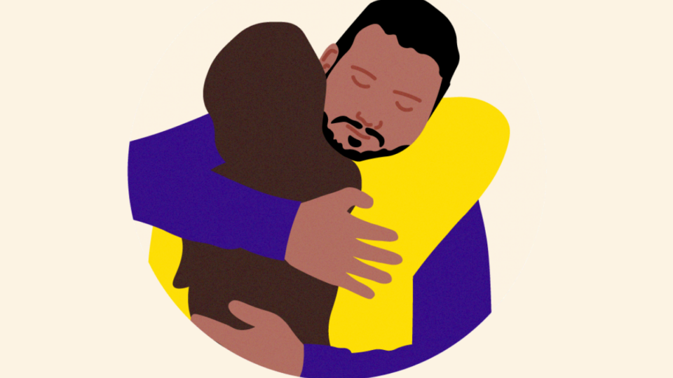 Two people hugging each other supportively.