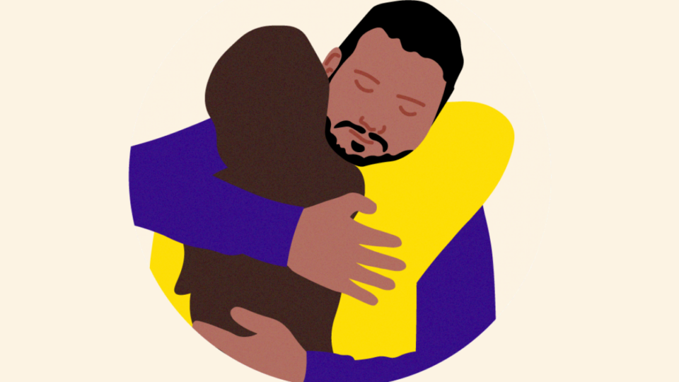 Two people hugging each other supportively.