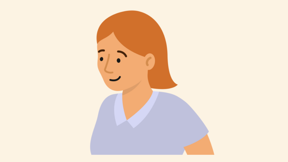 Lady with orange hair and a blue top, smiling.