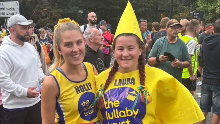 Two female runners in Lullaby yellow. One dressed as a star