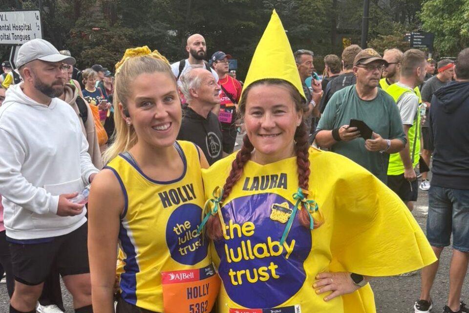 Two female runners in Lullaby yellow. One dressed as a star