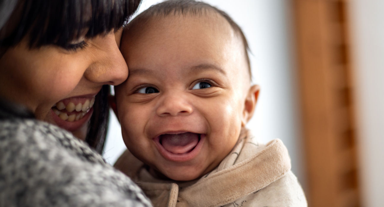 Baby smiling with mum