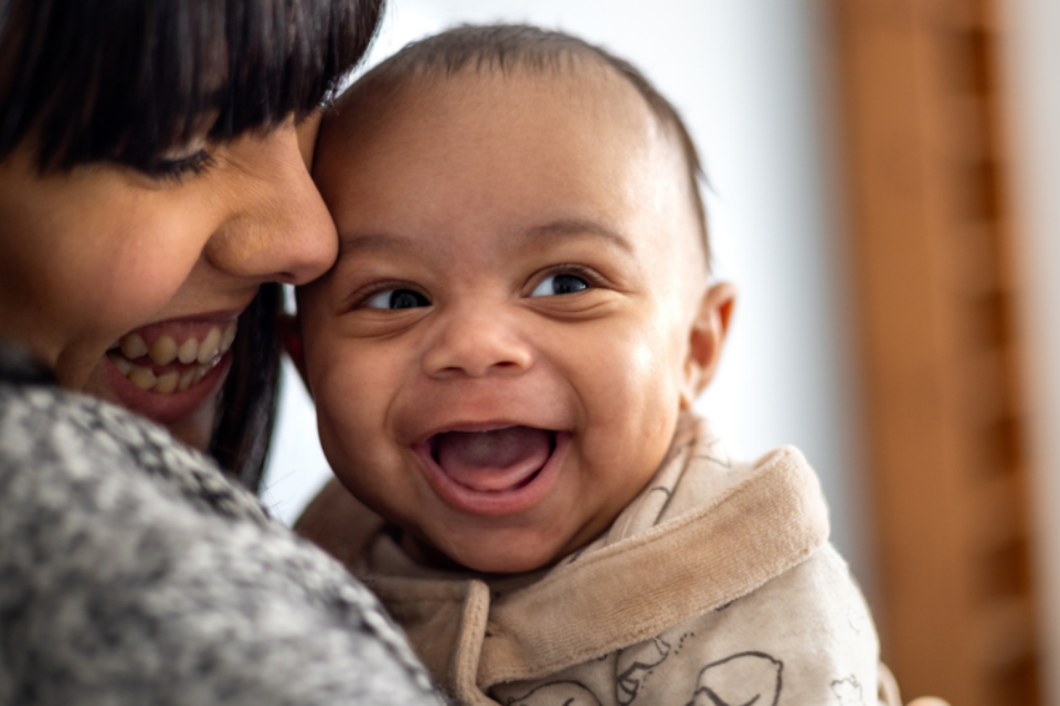 Baby smiling with mum