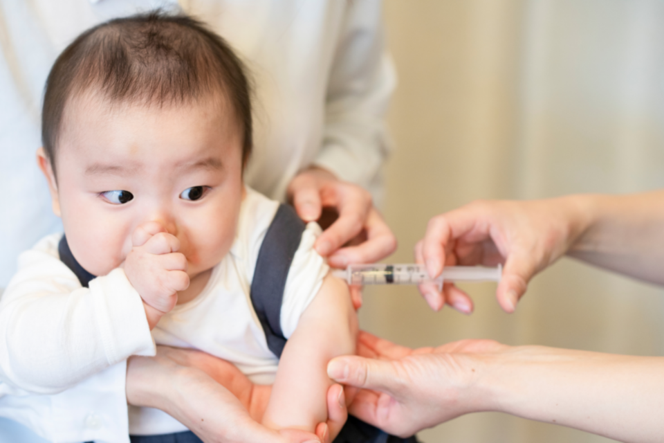 Worried baby getting a vaccination.