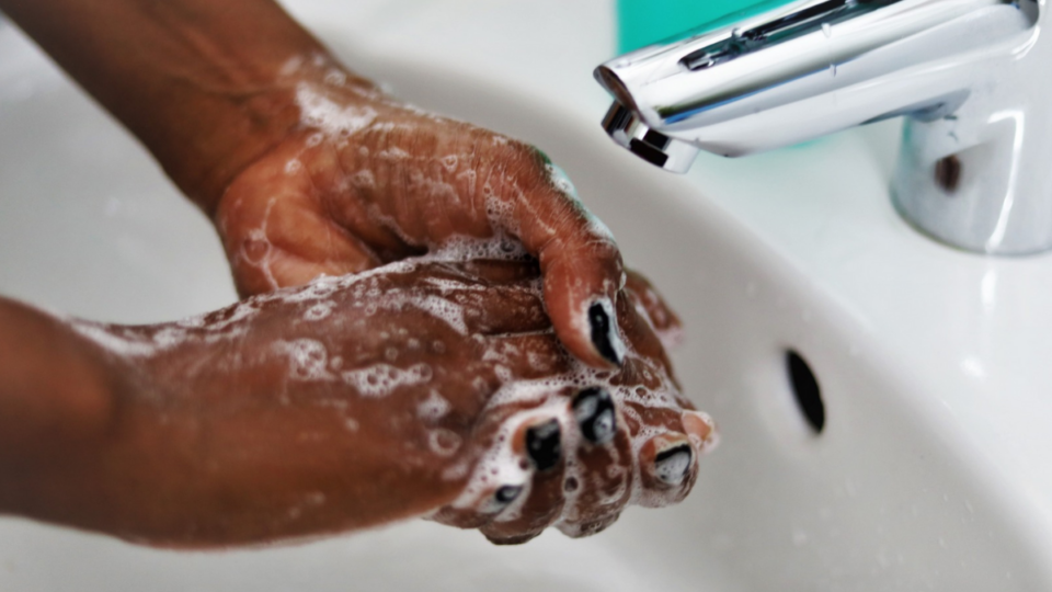 Person washing their hands.