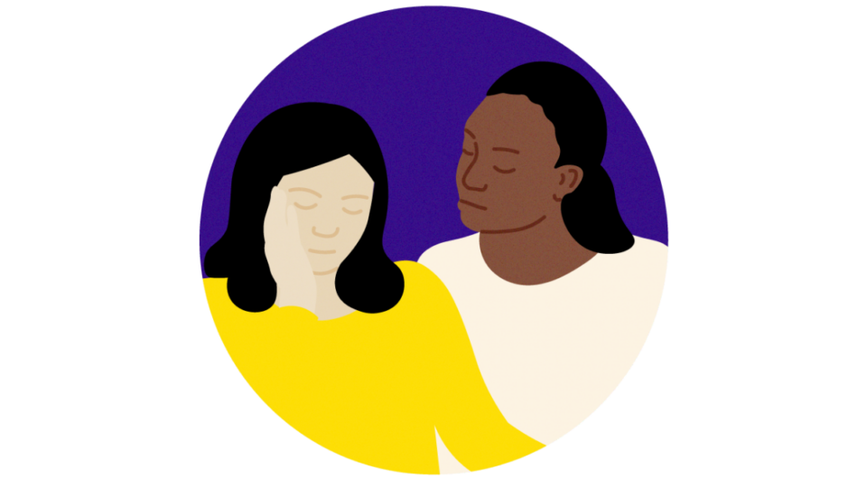 Lady sitting beside another person in support.