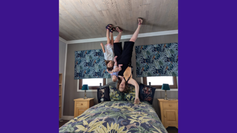 Lucy and her children in an upside down room fun house, so it appears they are standing on the ceiling!
