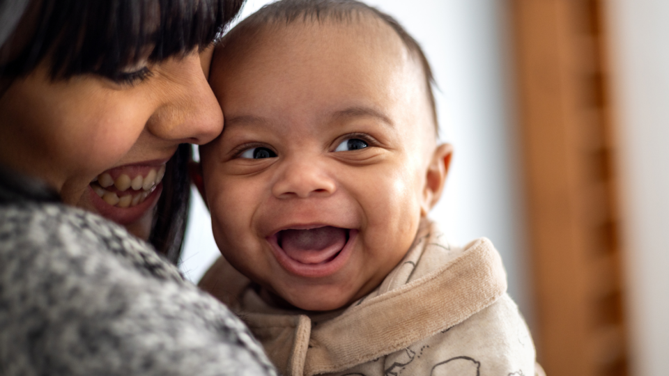 Baby smiling with mum