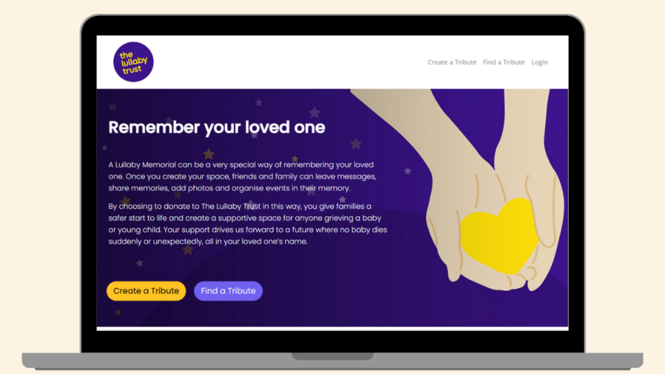 The Lullaby Memorial webpage open on a laptop. The page has an image of hands holding a heart.