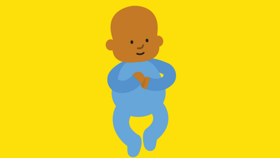 Baby in a blue babygrow, on a yellow background.