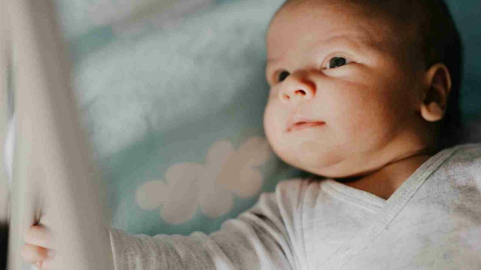 Baby lying down awake.