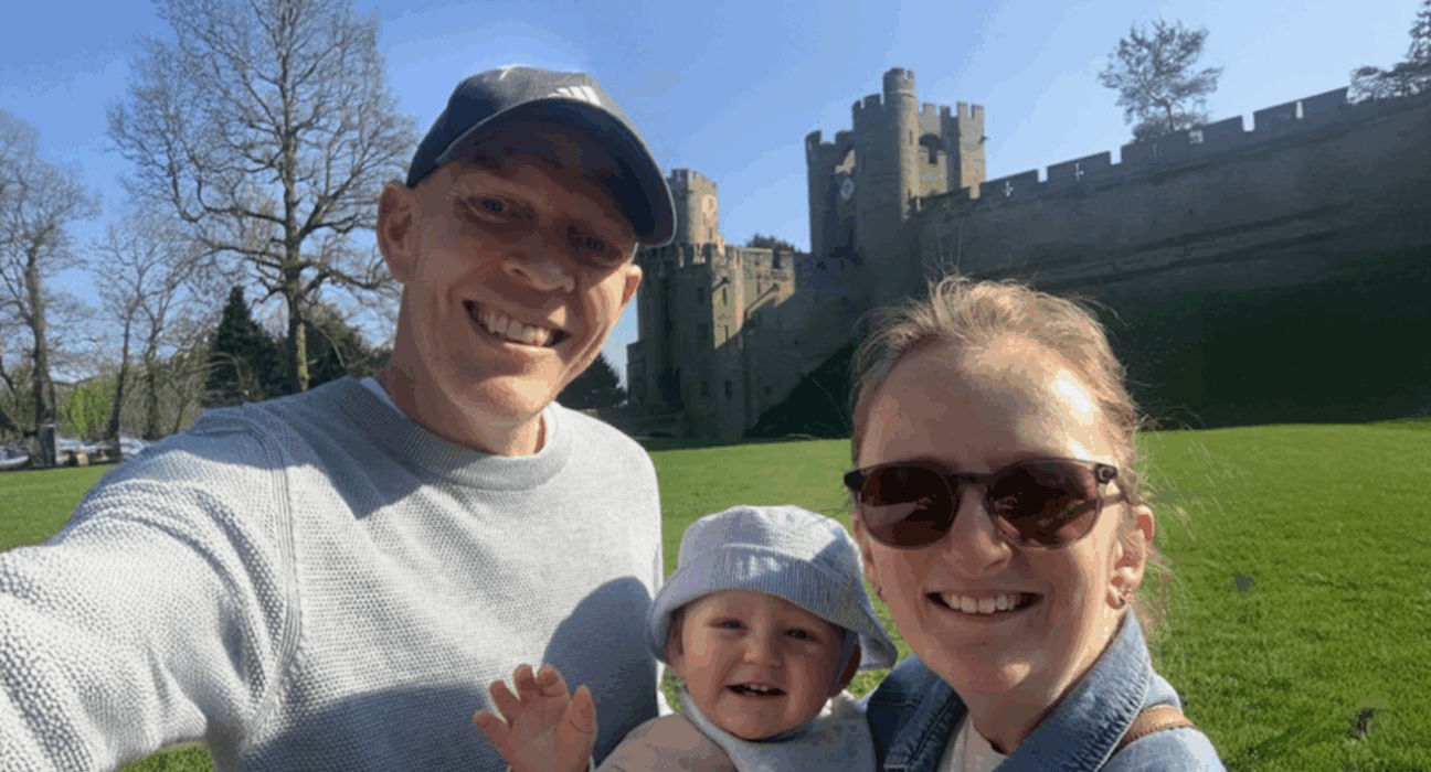 Mark taking a selfie, smiling at the camera on a sunny day with his fiancee May and his son Malyn.