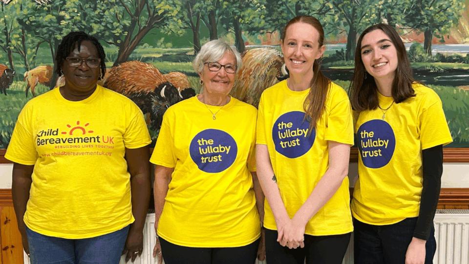 Four volunteers, three The Lullaby Trust T-shirts and a bereavement UK volunteer at the family day at Colchester zoo 2025