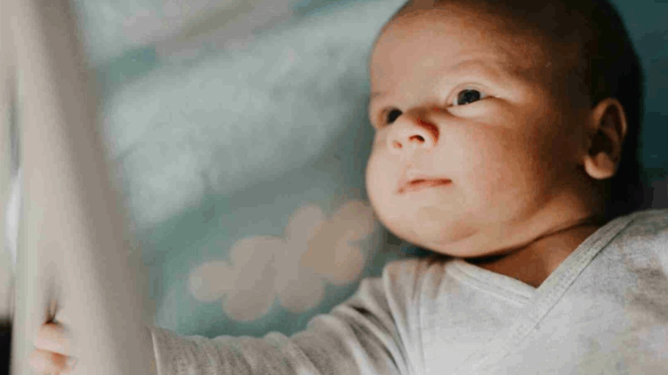 Baby lying down awake.