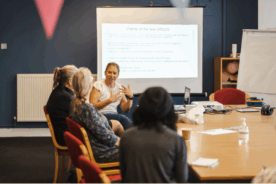 A group of women around a table at a meeting