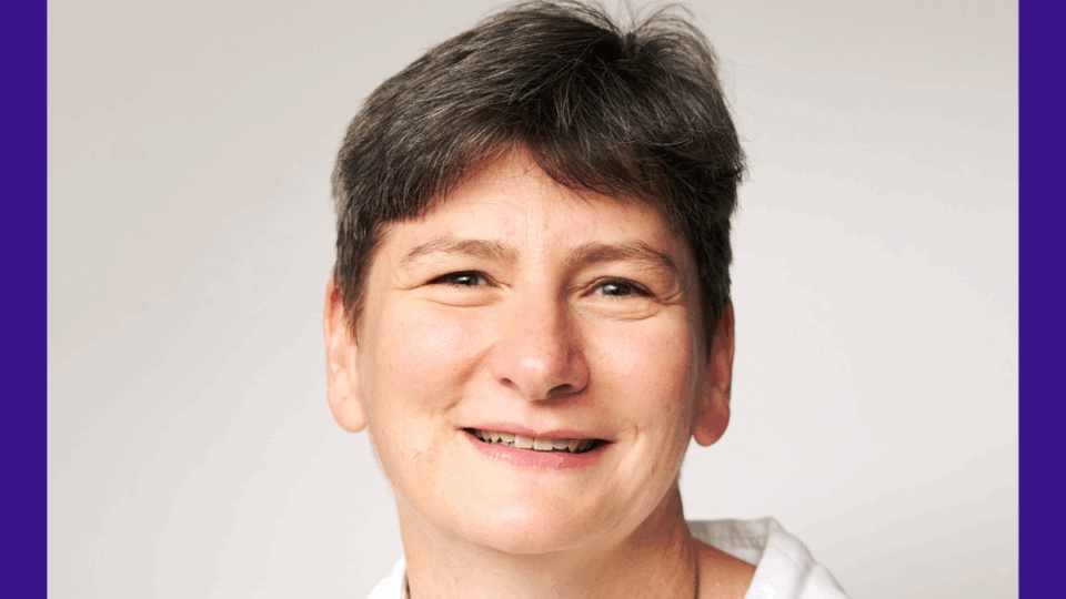 A professional headshot of Dr Joanna Garstang. She has short, dark hair, wears a white blouse, a silver necklace and is smiling.