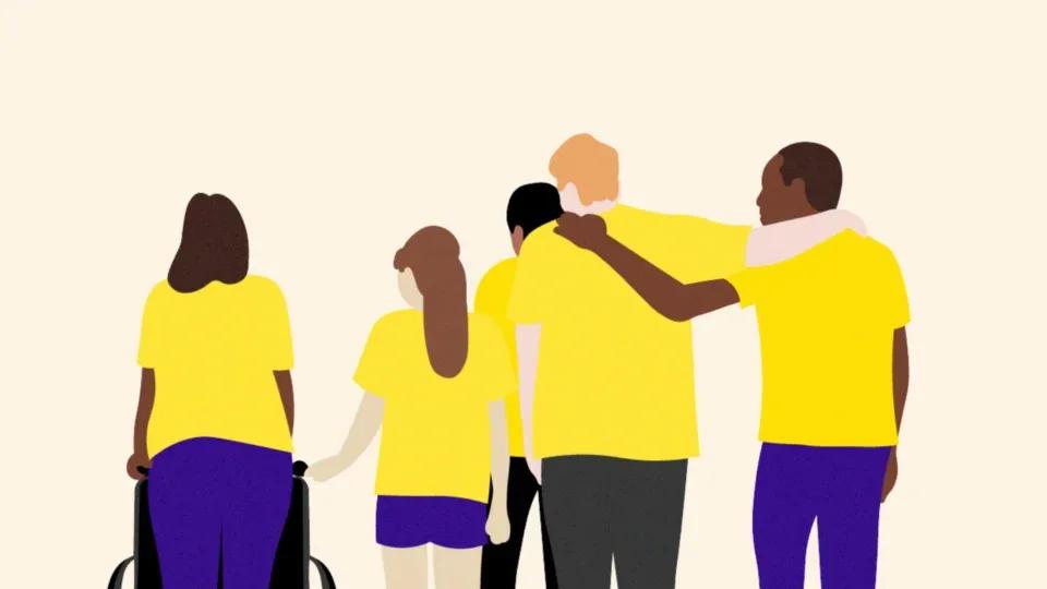 People with their backs to us with their arms around each other, all wearing yellow t-shirts.