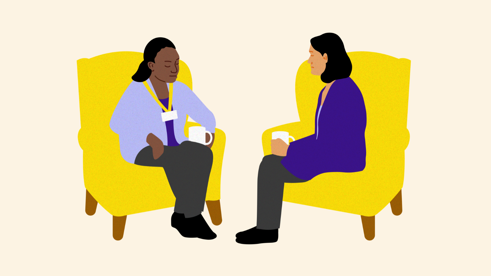 Two people sitting on yellow armchairs facing each other. One person has a mug in their hand.