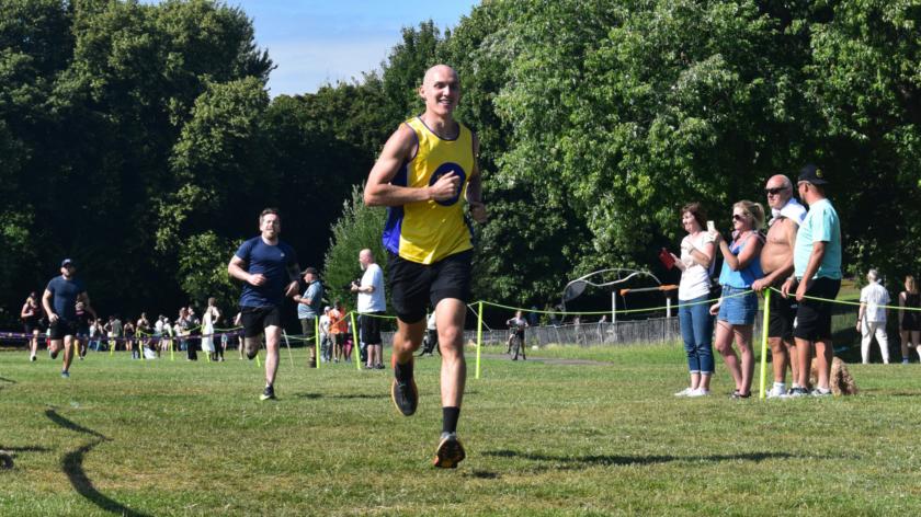 A man in a lullaby vest running
