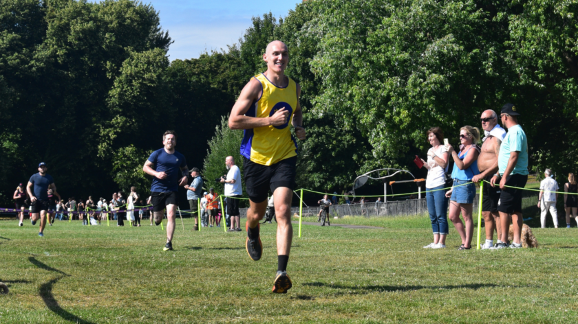 A man in a lullaby vest running