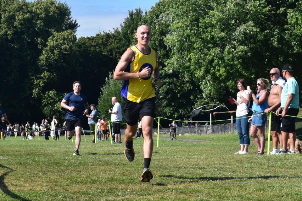 A man in a lullaby vest running