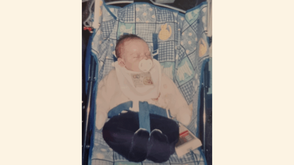 Baby Owen sitting in his pram.