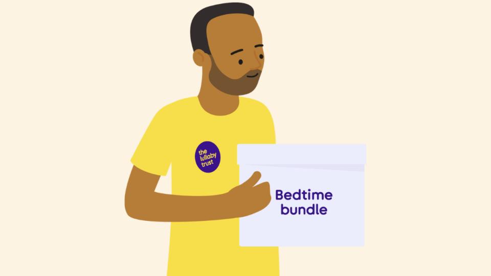 Man wearing a yellow Lullaby Trust t-shirt, holding a box labelled 'Bedtime Bundle'.