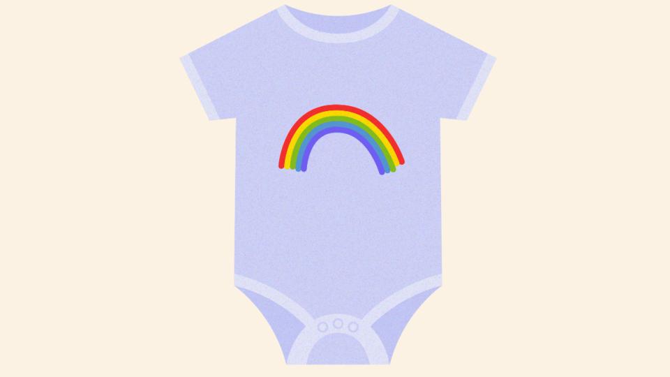 A babygrow with a rainbow on it.