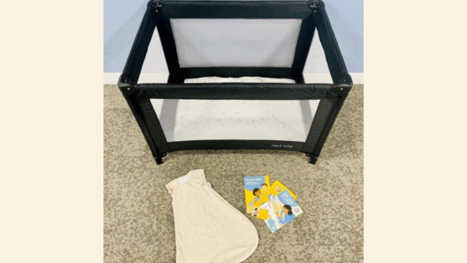 Contents of a Bedtime Bundle. A travel cot, a sleep bag, leaflets.