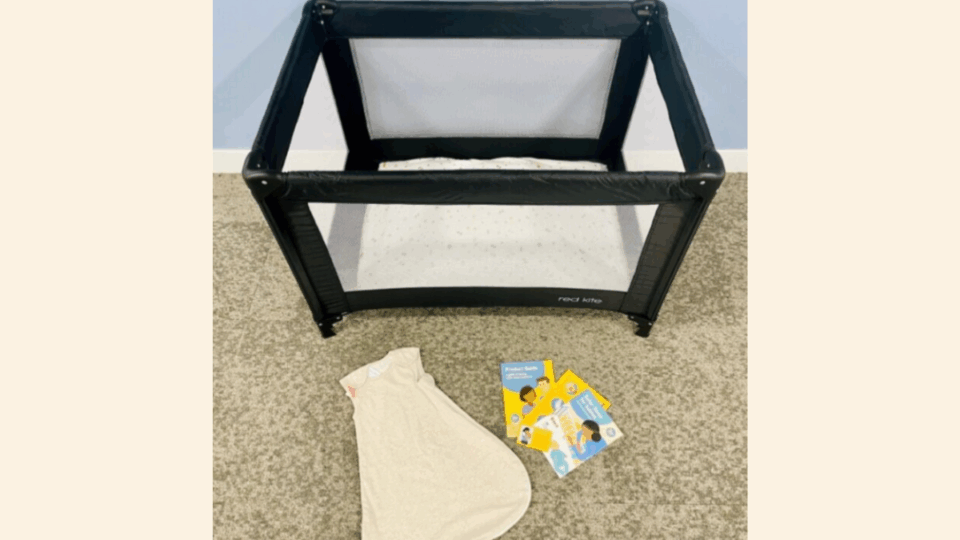 Contents of a Bedtime Bundle. A travel cot, a sleep bag, leaflets.