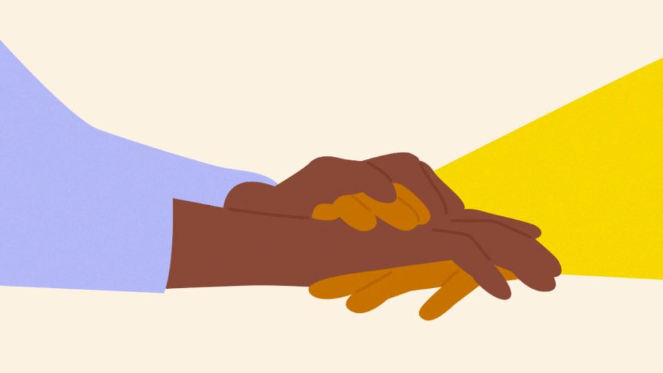 Close up of holding hands in support.