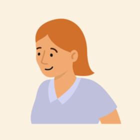 Lady with orange hair and a blue top, smiling.