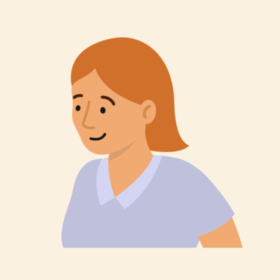 Lady with orange hair and a blue top, smiling.