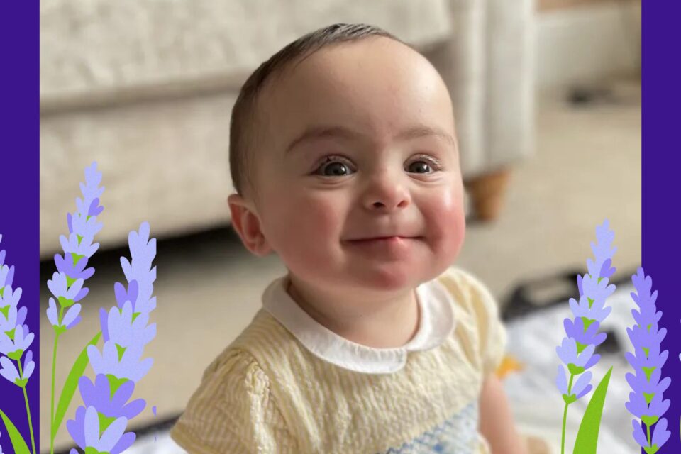 Gigi grins brightly wearing a yellow dress. Her image is surrounded by illustrated lavender.
