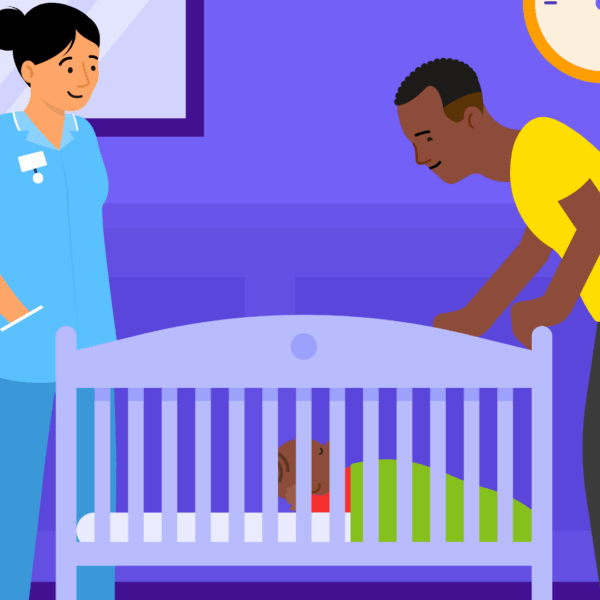 A health professional standing next to a cot, with a father also standing beside the cot. The baby is on their back in the cot.