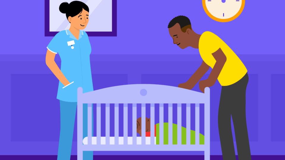 A health professional standing next to a cot, with a father also standing beside the cot. The baby is on their back in the cot.