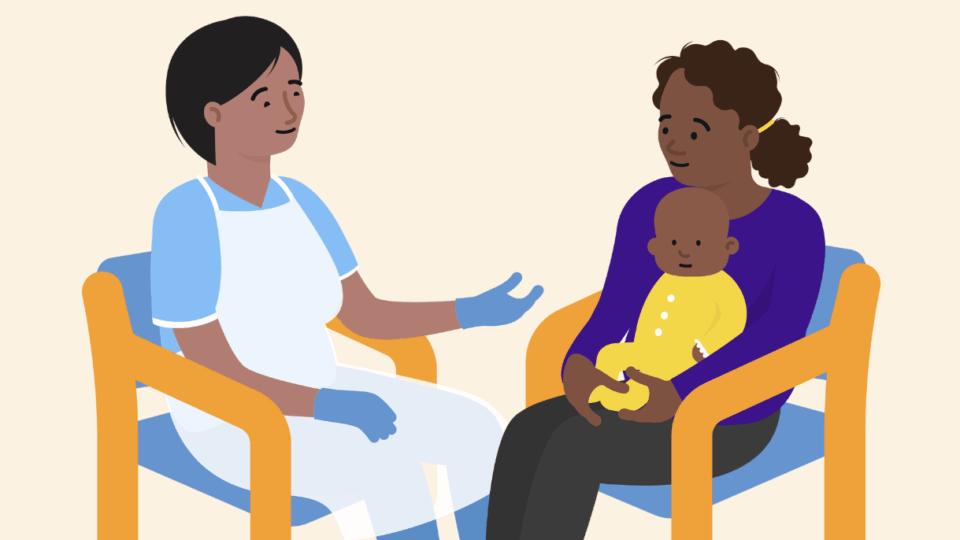 A health professional sitting on a chair, opposite a mum sitting on a chair with her baby on her lap, having a conversation.