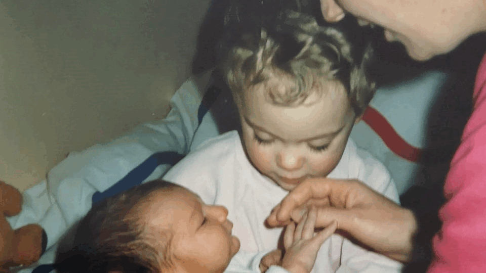 Judi holding baby Adam, with her daughter Vikki beside her.